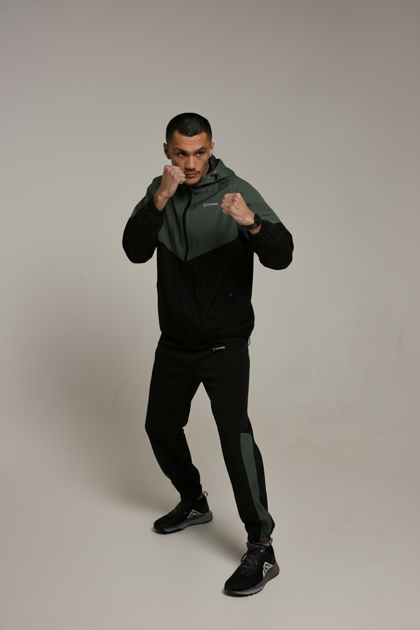 Green and black tracksuit boxing stance