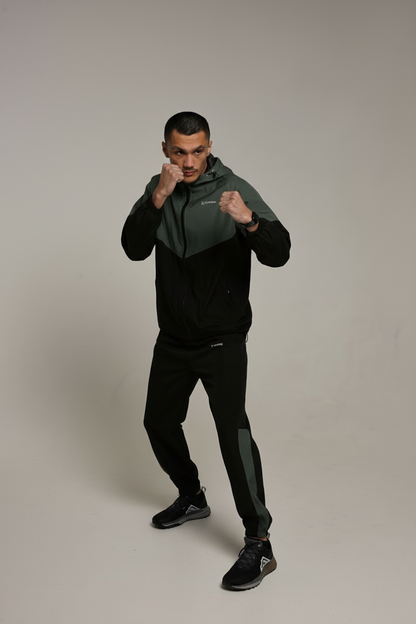 Green and black tracksuit boxing stance